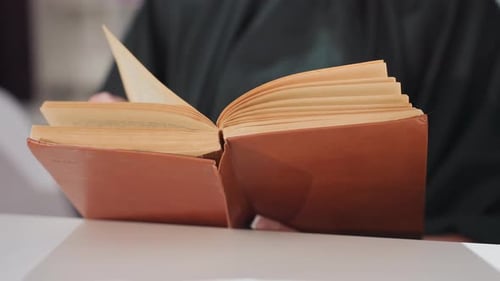 Close-up of person turning pages in a book