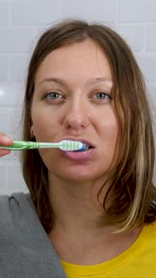 Cute Female Brush Teeth in Bathroom