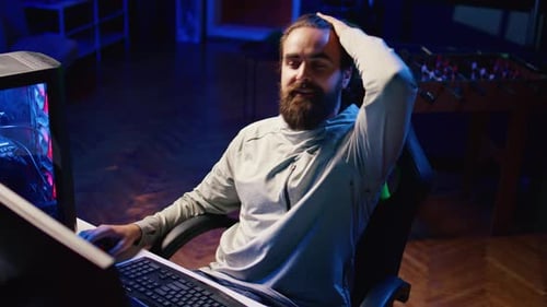Bearded Man at Computer Desk Gesturing