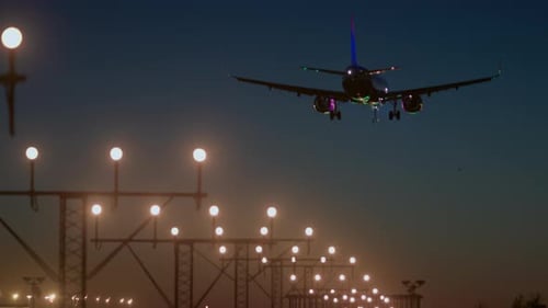 Airplane Landing on Illuminated Runway