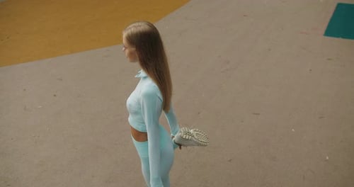 Young Woman Stretches Leg Before Workout