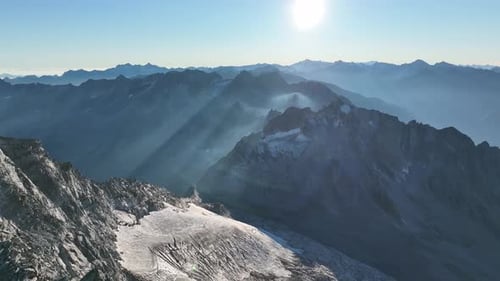 Aerial footage of a small glacier field and a surrounding mountain ridge in the mountains of South T