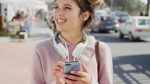 Woman, phone typing and social media in city street, urban lifestyle and outdoor on mobile app