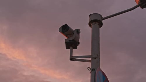 CCTV camera on the pole street during colorful sunset Concept of surveillance, privacy, criminal, te