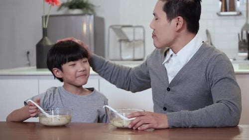 Loving Father and Son Eating Soup Together