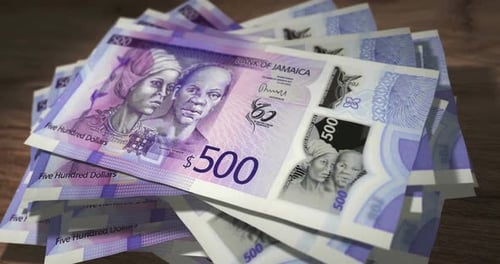 Jamaica dollar money banknotes falling on the table