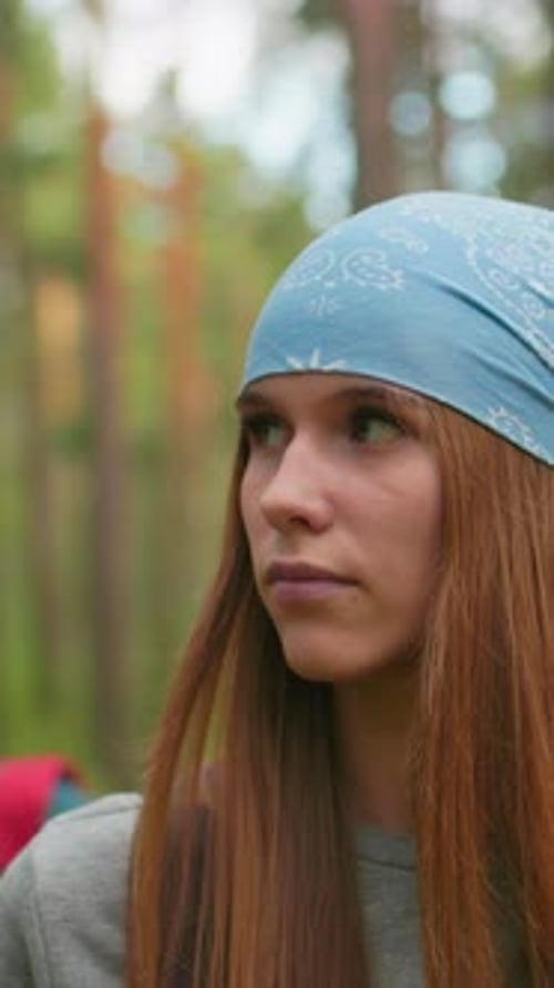 Woman in Blue Bandana Hiking Along Forest Trail with Friend
