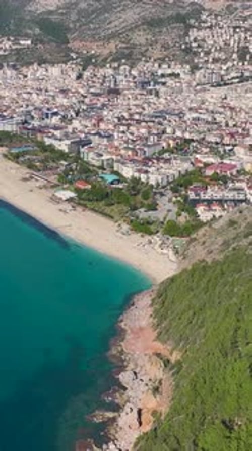Vertical Video People Relaxing on a Beautiful Beach With Bright Sun and Clear Blue Waters Captured