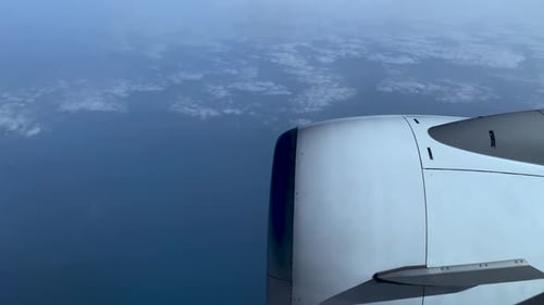 Airplane Engine Flying Over Blue Skies and Clouds