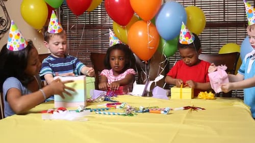 Children Opening Presents at a Birthday Party