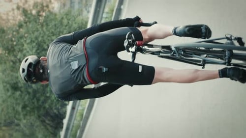 Cyclist Riding Bike on Paved Road