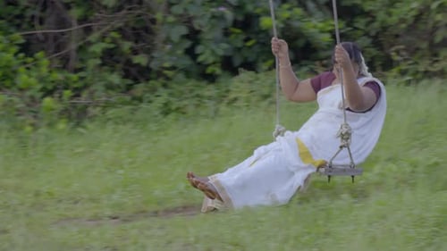 Woman in Saree Swinging in Tropical Nature