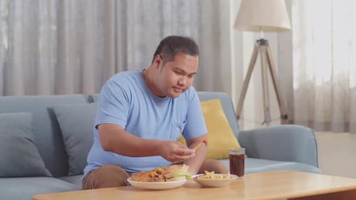 Man Eating Fast Food on Couch