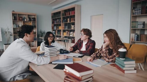 Group of diverse students studying together in a library