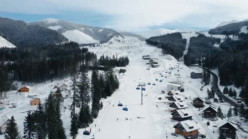 Modern ski resort with slopes covered with snow aerial view