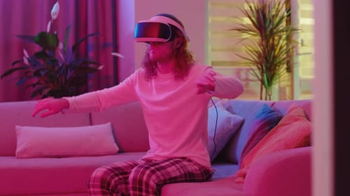 Man Wearing VR Headset Gesturing in Living Room