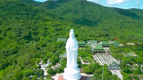 Aerial View of the Majestic Lady Buddha Statue Surrounded By Lush Greenery Demonstrating Serene