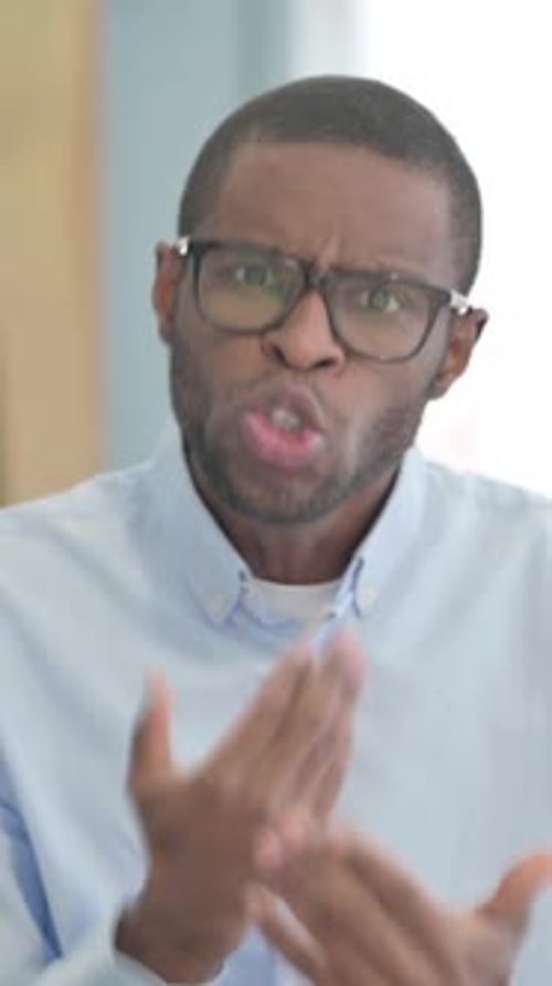 Upset Man Arguing and Gesturing in Vertical Video