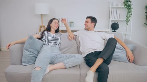Couple Relaxing on Sofa Together at Home