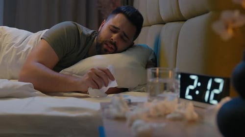 Sick Man Lying Awake in Bed at Night