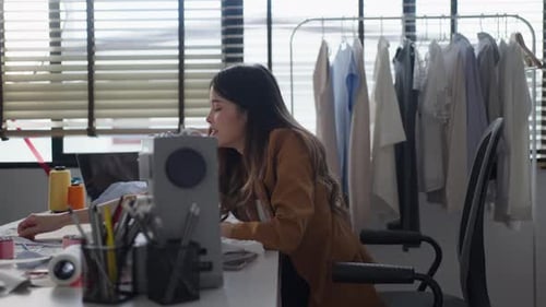 Fashion Designer Arranging Fabric at Bright Studio Workspace