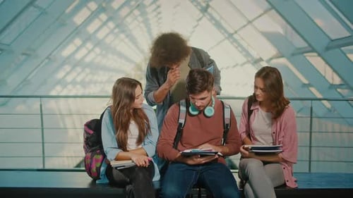 Students Talk While Sitting on Bench at University Hall
