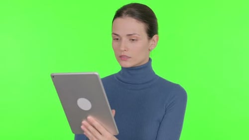 Beautiful Woman using Digital Tablet on Green Background