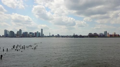 Drone Slide Right with Boat in Hudson River - New York City, Jersey City Background