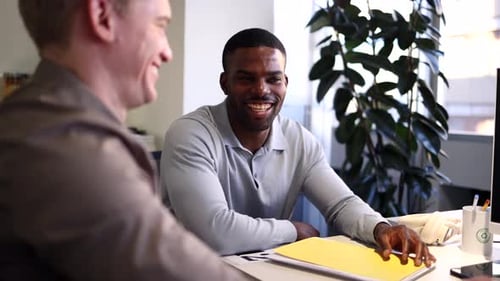 Coworkers discussing business strategy in modern office