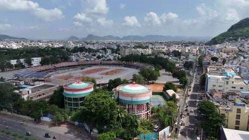 Aerial Drone shot of Vijayawada Ground for sports academy with buildings and mountains nearby