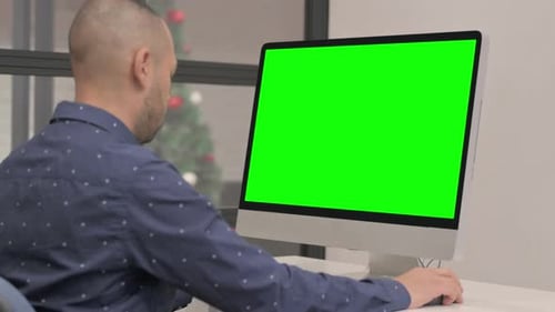 Hispanic Businessman Working on Computer with Green Screen