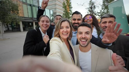 Smiling Group Poses Together for a Selfie in City