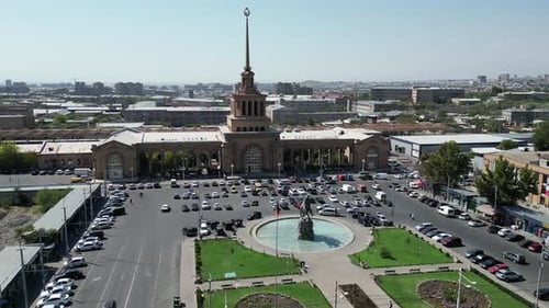 Aerial dolly: Cars parked at plaza by Yerevan Railway Station, Armenia