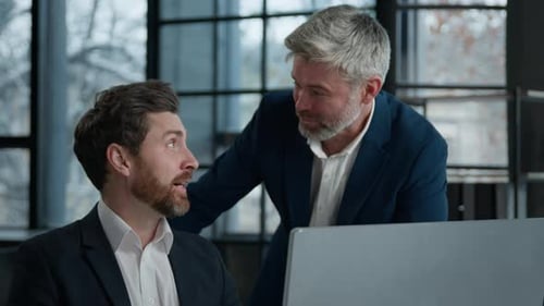 Two Men Collaborating in a Modern Workplace