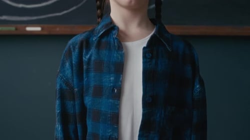 Portrait of Smiling School Girl in Front of Chalkboard Solar System Diagram