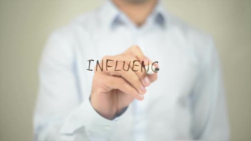 Hand Writing the Word Influence on Surface