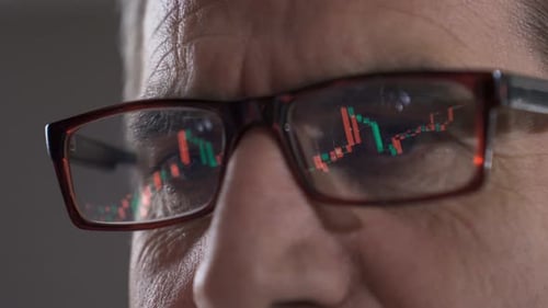 Trader analyzing charts, trading cryptocurrencies on online stock market.