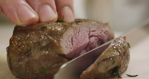 Chef Cutting Delicious Steak Close Up