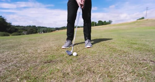 Male golf player playing golf and knocking golf ball out on golf course, copy space