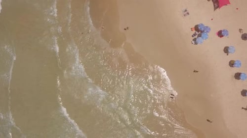Summertime in a public Beach with colorful umbrellas