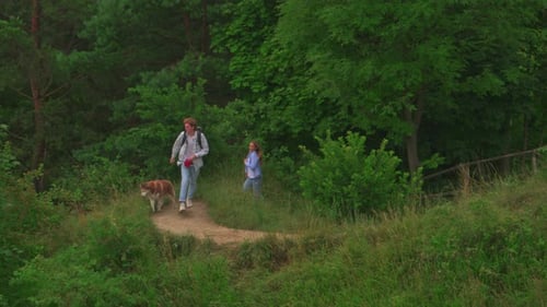 Couple Hiking with Dog in a Natural Setting