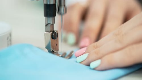 Dressmaker Working on Sewing Machine in Studio at Table. Professional Occupation Of