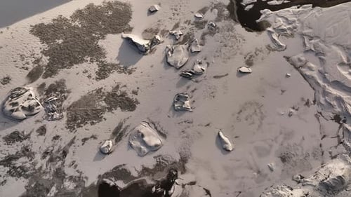 Aerial top view of ice melting from Sólheimajökull glacier, climate change, global warming, Iceland