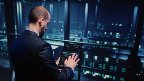 Datacenter Engineer Using Tablet in Modern Server Room
