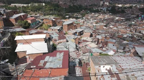 Dense rooftops of Comuna 13 with city backdrop in Medellin, Colombia
