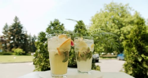Refreshing Drinks with Lemon and Mint Outside