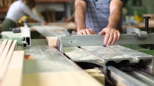 Carpenter Cutting Wood with Circular Saw