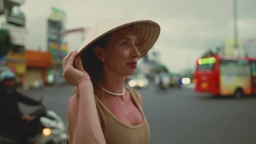 Beautiful Caucasian Female Tourist in Traditional Asian Hat Standing in City Portrait of Inspired