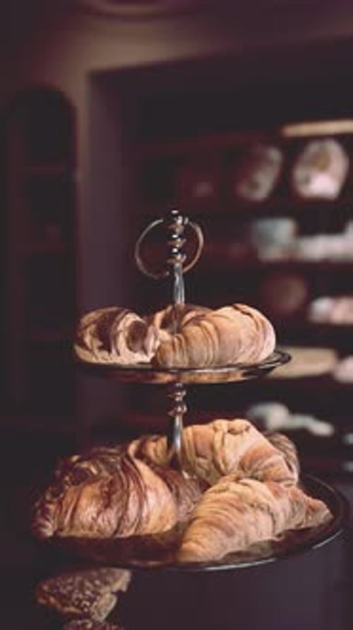 Rotating Croissants Display in a Cozy Bakery Setting