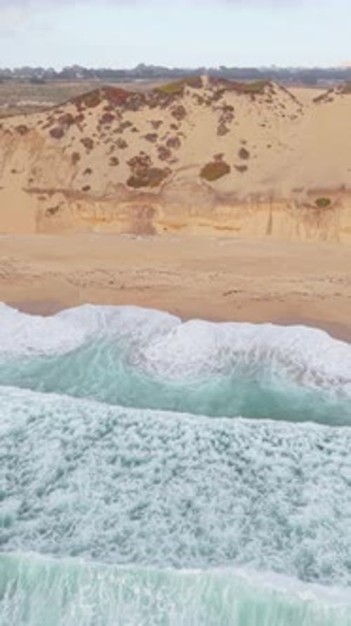 Top-Down Drone View of Waves and Sand at Fort Ord Beach.